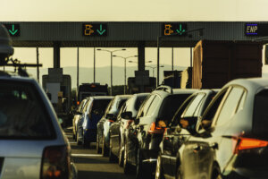 Cars and trucks waiting at point of toll highway