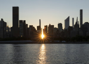 Manhattan skyline silhouette at sunset.