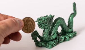 Traditional figurine of the symbolic Chinese dragon and 1 US dollar coin
