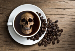 Still life photography, human skull soak in white coffee cup in harmful effect from Caffeine concept