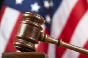 Judge's gavel against American flag in the background. Canon 5D Mark II.