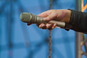 microphone in a hand of singer turned to the audience