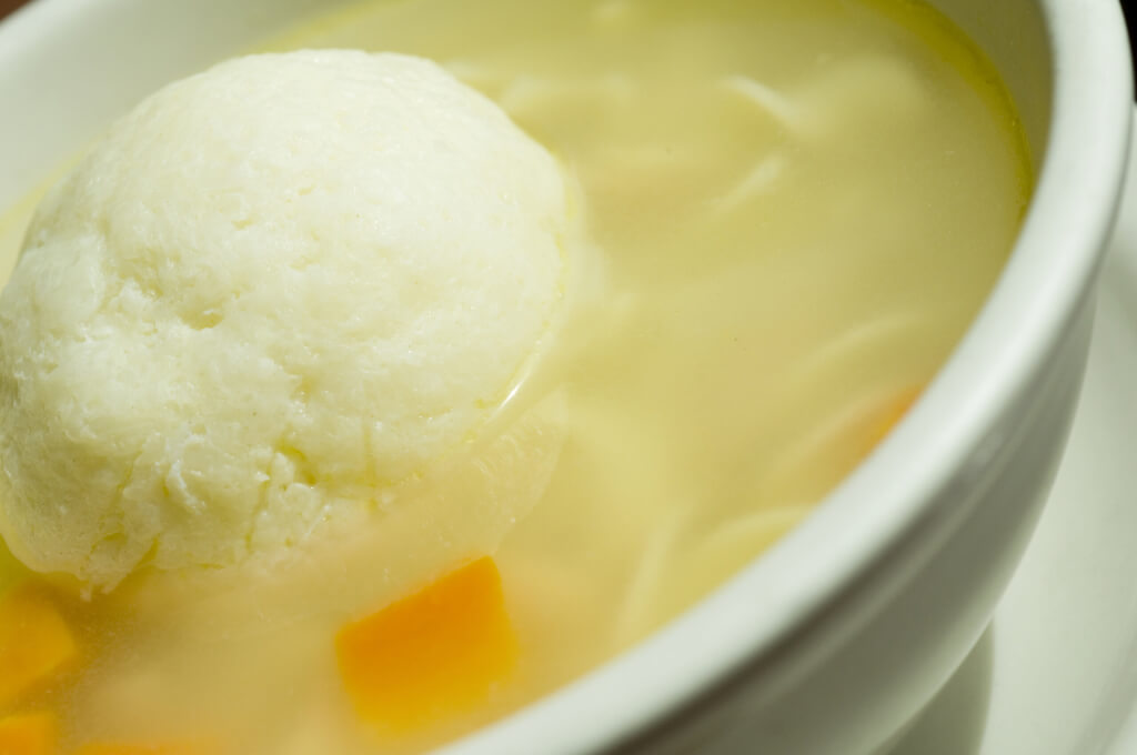 Bowl matzoh ball soup. Bowl of matzoh ball soup with carrots and chicken broth
