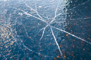 Cracks on thin ice - danger of walking on ice - risk of falling into water
