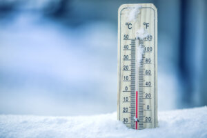 Thermometer on snow shows low temperatures
